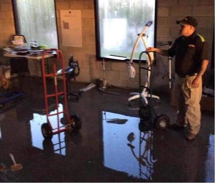 Clean up crew working on a flooded office area.