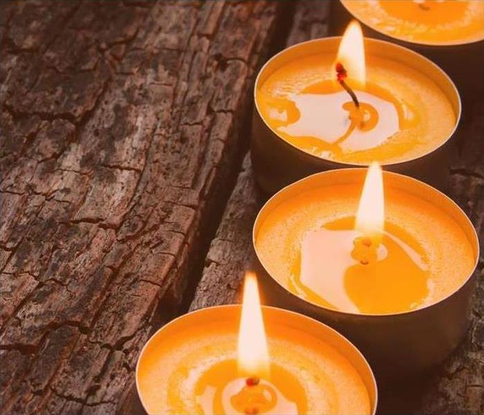 Row of four lit orange candles
